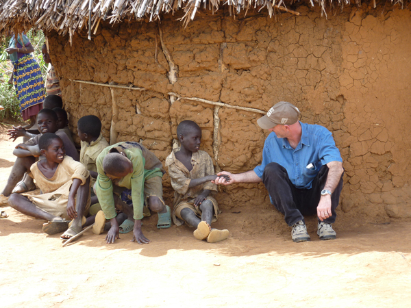 Producer David Bottrill interacts with some children in a village that CARE is supporting
